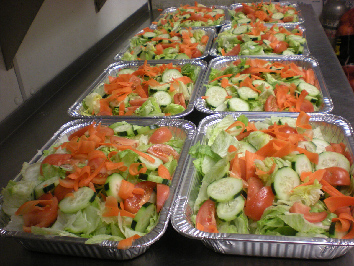 Catering salad trays prepared for party orders at Las Vegas Pizza