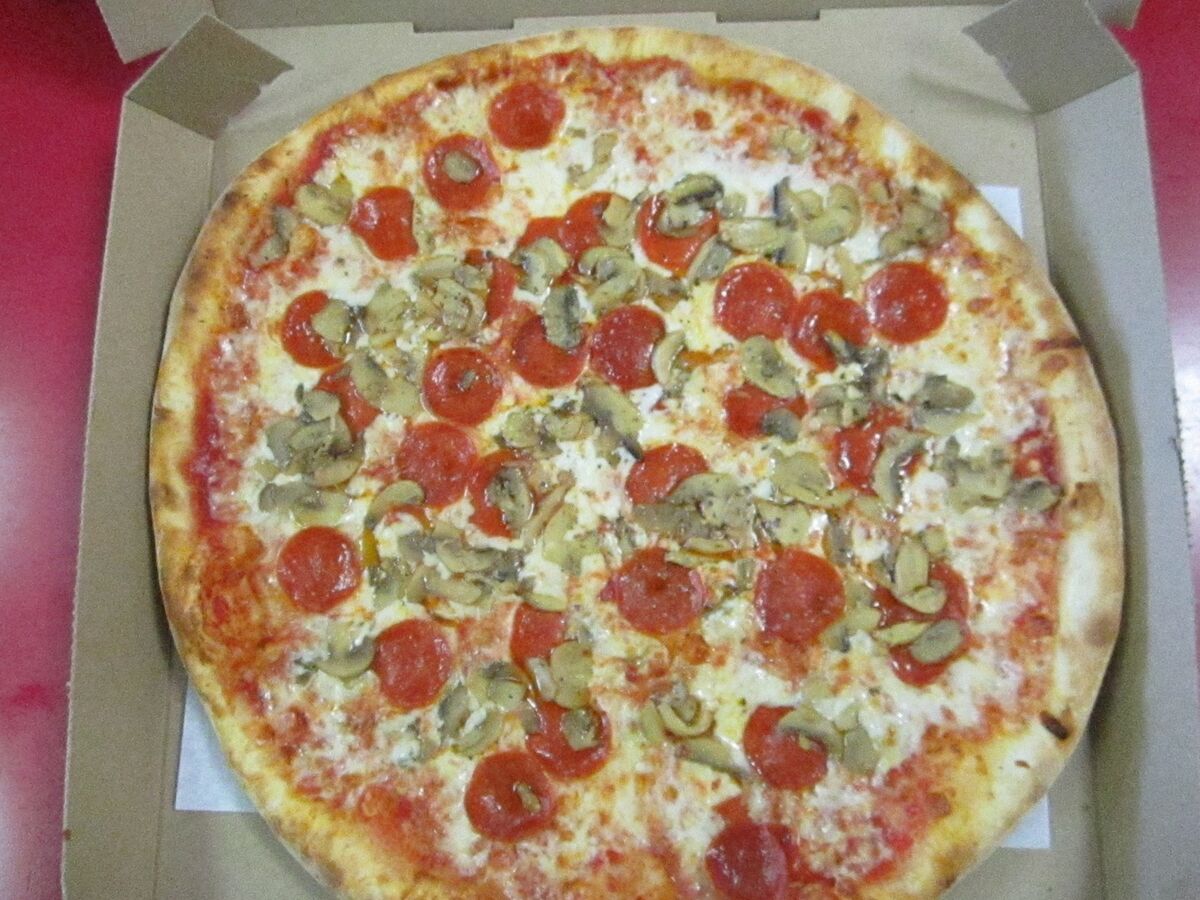 Fresh pepperoni and mushroom pizza in takeout box from Las Vegas Pizza