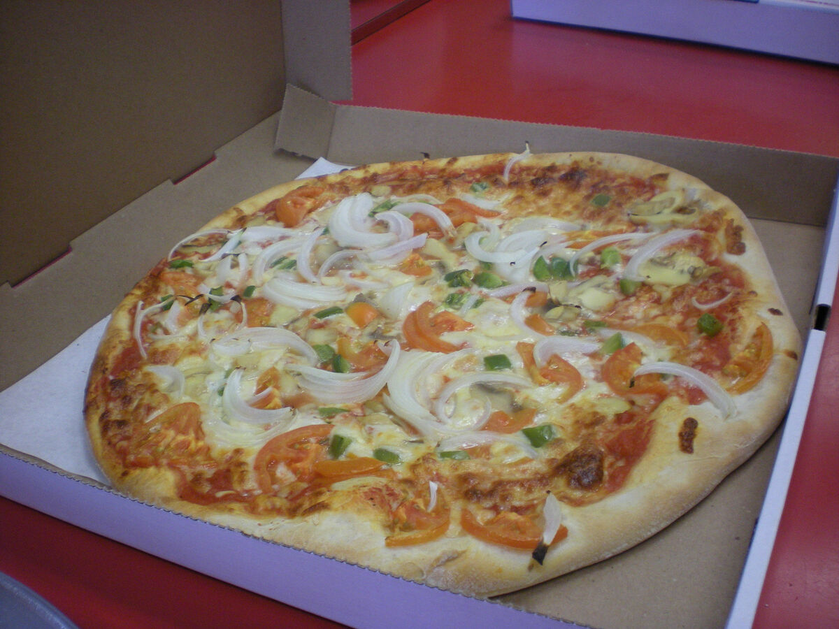Vegetable pizza with broccoli peppers and olives in takeout box from Las Vegas Pizza